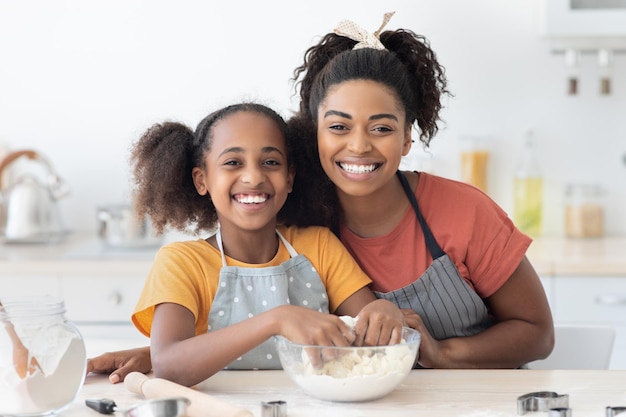 Cheerful african american family making cookies at home