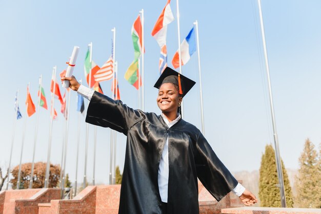 Cheerful african american graduate student with diploma in her hand