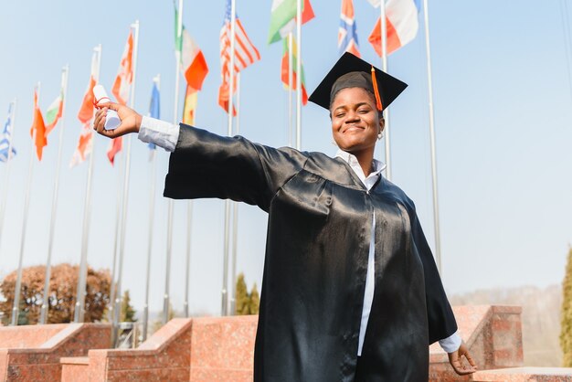 Cheerful african american graduate student with diploma in her hand