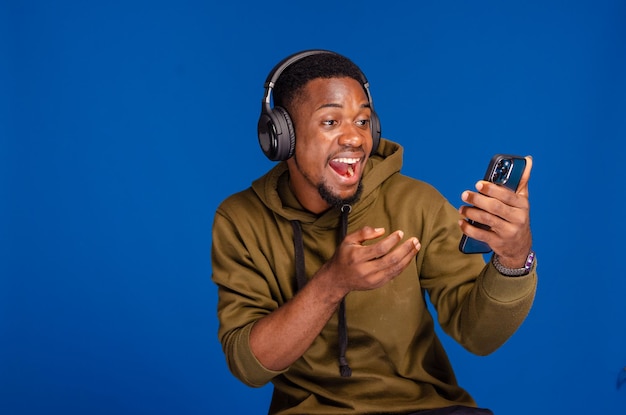 Cheerful african american man using mobile phone application