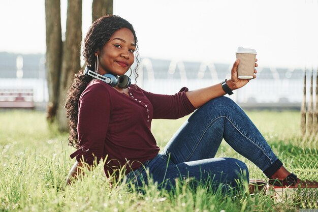 Cheerful african american woman in the park at summertime