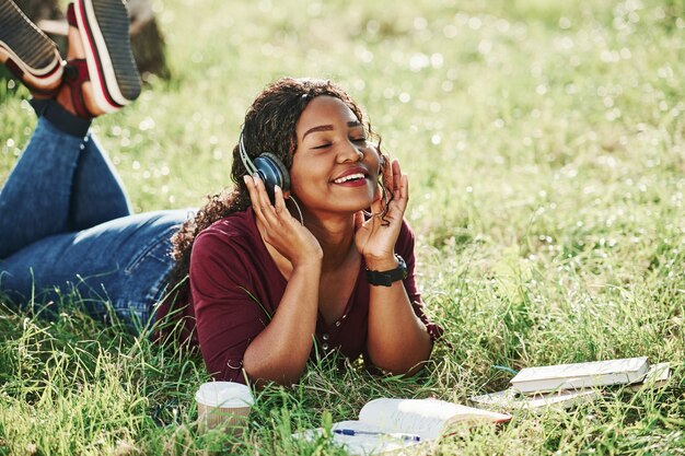 Cheerful african american woman in the park at summertime