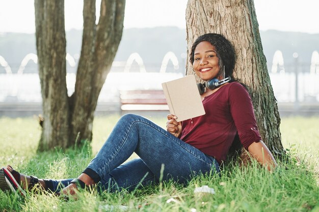 Cheerful african american woman in the park at summertime