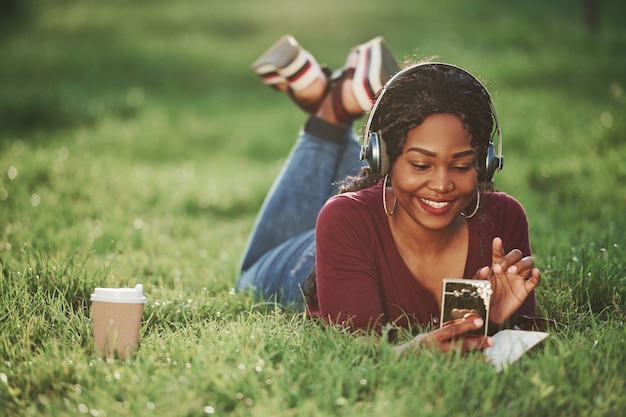 Cheerful african american woman in the park at summertime