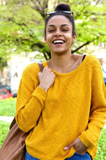 Cheerful african woman walking outdoors