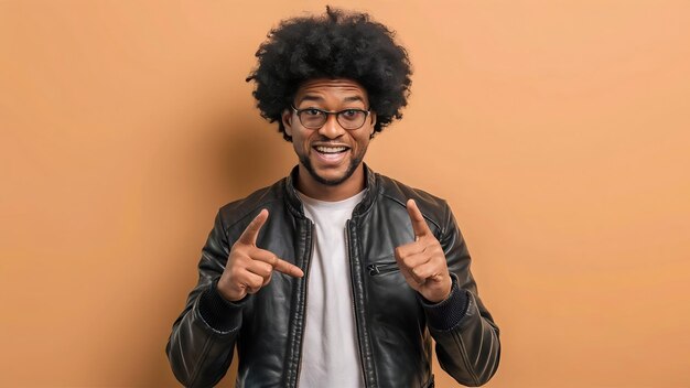 Cheerful afro american man in leather jacket pointing with two fingers looking