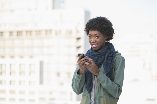 Cheerful afro model texting