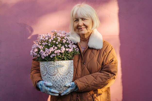  Cheerful aged woman doing a hobby and enjoys gardening.