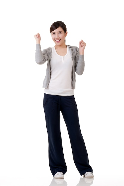 Cheerful Asian girl, full length portrait with reflection on white background.