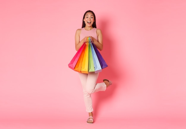 Cheerful Asian girl posing in the studio