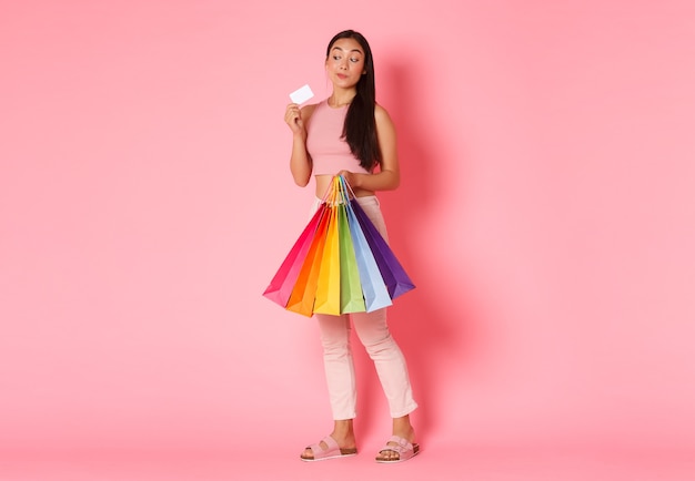 Cheerful Asian girl posing in the studio