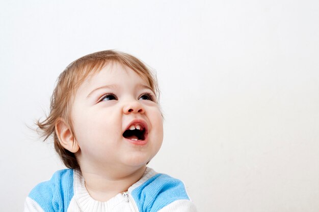 Cheerful baby looking up with his mouth open