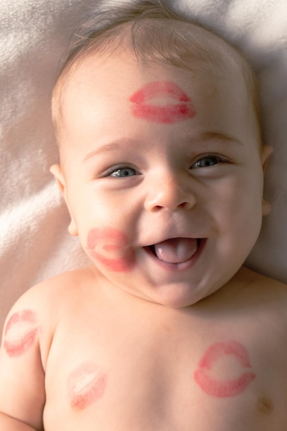 Cheerful baby with traces of kisses on the body. Valentine's day, concept.