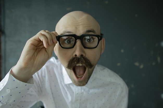 Photo cheerful bald man with a mustache, portrait of a young man smiling, posing, mustachioed mister