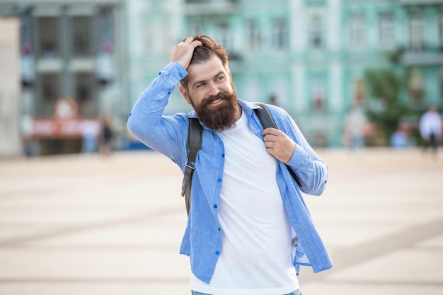 Cheerful bearded guy is outside portrait of guy with beard\
brutal casual guy outdoor