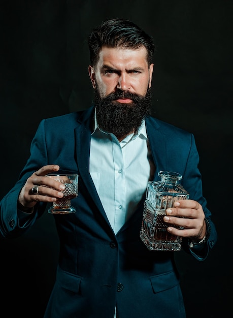 Cheerful bearded man is drinking expensive whisky confident welldressed man with glass of whisky bus