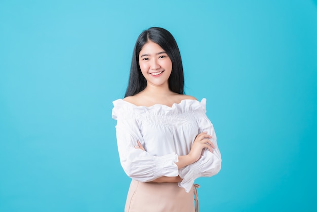 Cheerful beautiful Asian woman stand and crossed arms