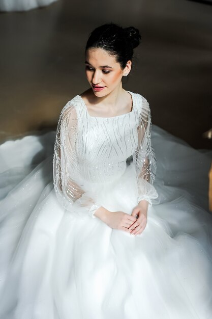 Cheerful beautiful bride in the interior