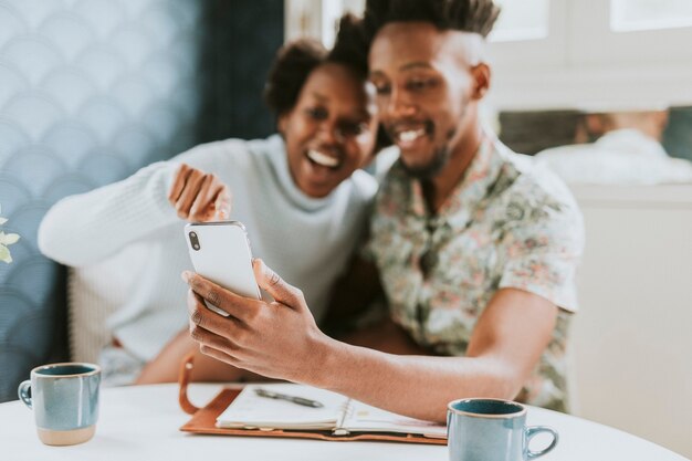 Cheerful black couple taking a picture