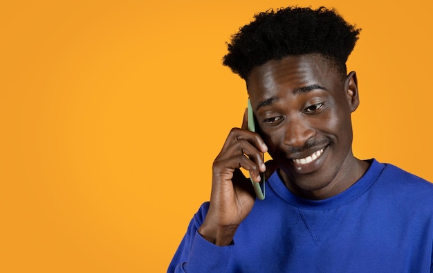 Cheerful black man using smartphone have phone call