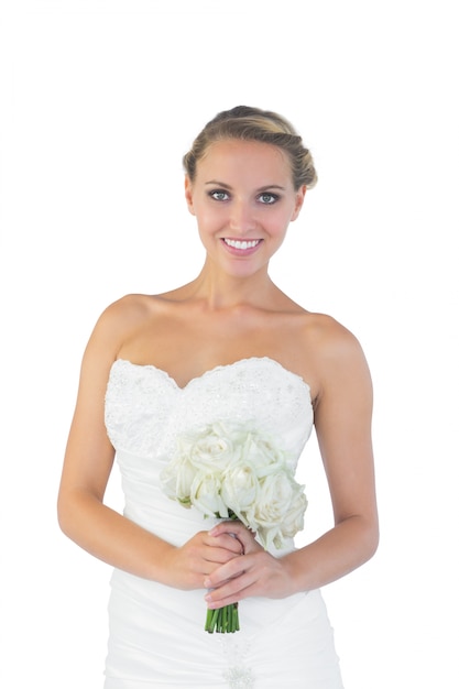 Cheerful blonde woman posing holding a bouquet