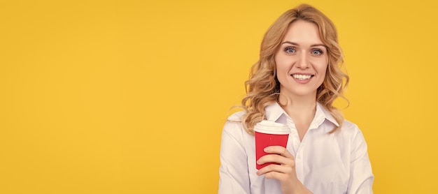 Photo cheerful blonde woman with morning coffee cup on yellow background woman isolated face portrait