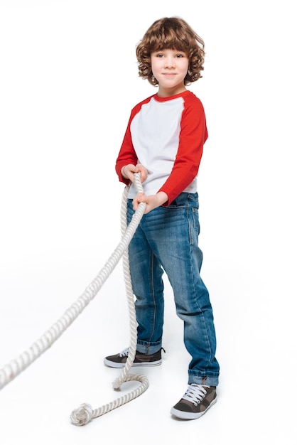 Cheerful boy play tug of war isolated on white children sport concept