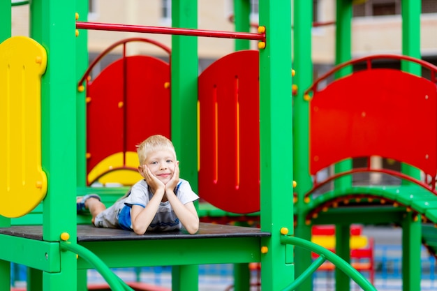 A cheerful boy at the playground on a summer day