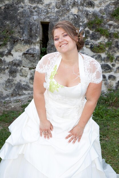 Cheerful bride blonde outdoor in park