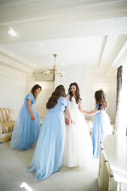 Cheerful bride and bridesmaids with bouquets