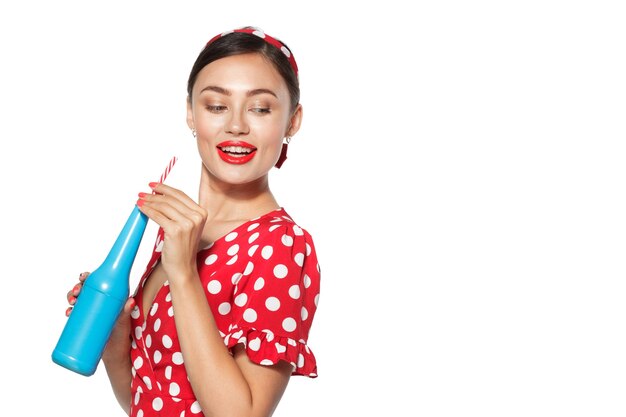 Cheerful brunette pin-up girl holding soft drink