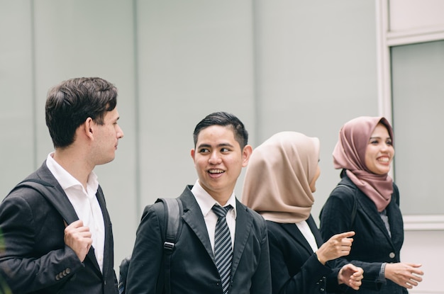 Cheerful business people walking on road