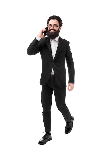 Cheerful businessman in formalwear talking on the phone, isolated on white background