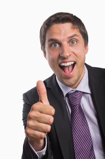 Cheerful businessman gesturing thumbs up