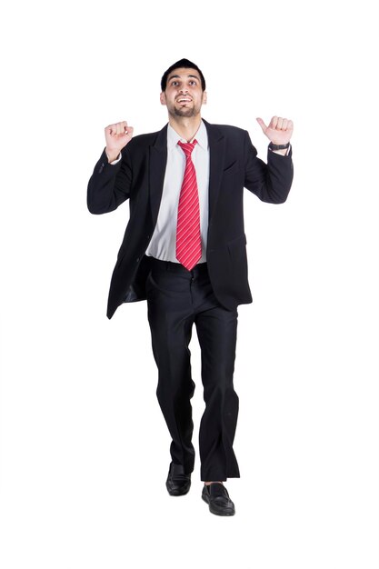 Cheerful businessman jumping in studio