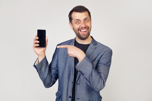 Cheerful businessman man showing smartphone screen