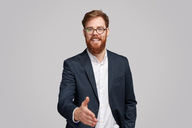 Cheerful businessman offering hand for handshake