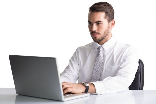 Cheerful businessman using laptop at desk 