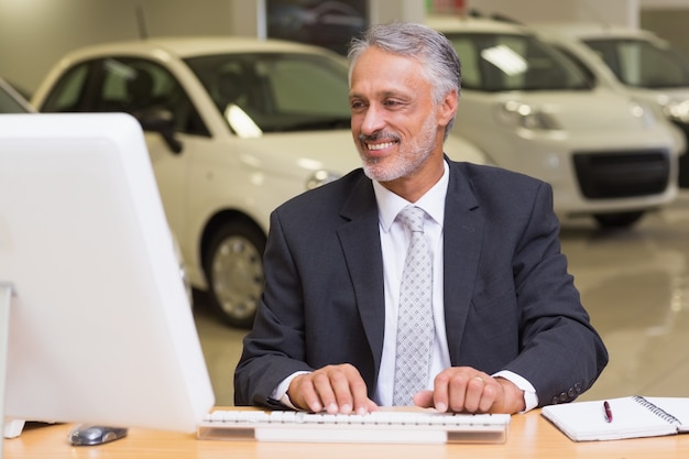 Cheerful businessman working at his desk