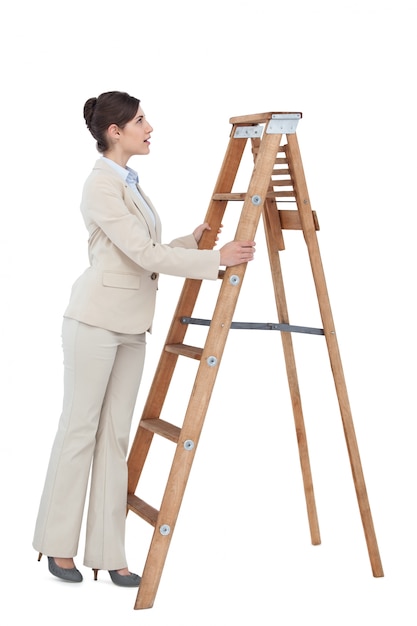 Cheerful businesswoman looking up the career ladder