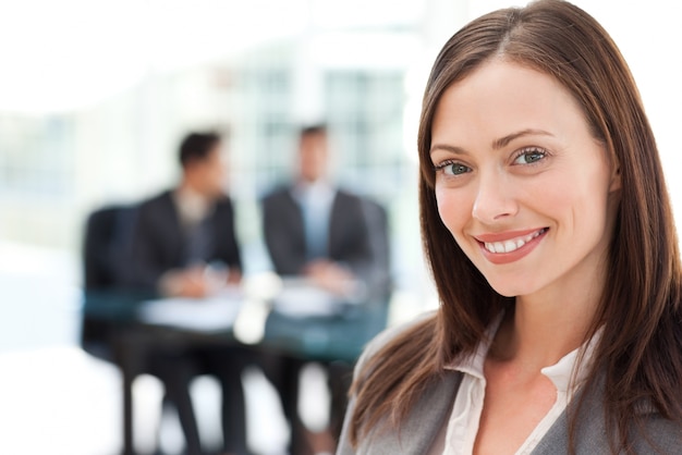 Cheerful businesswoman during a meeting with her two male colleagues