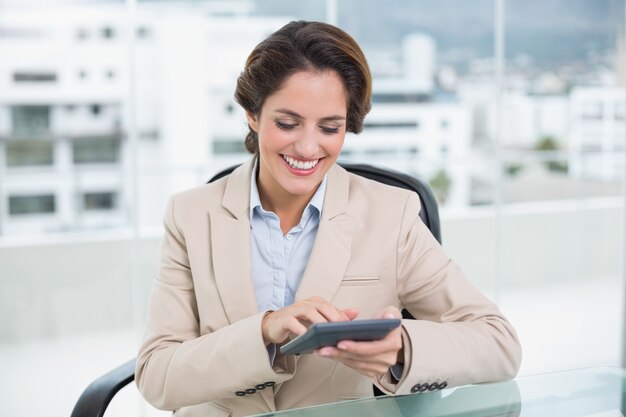 Cheerful businesswoman using calculator