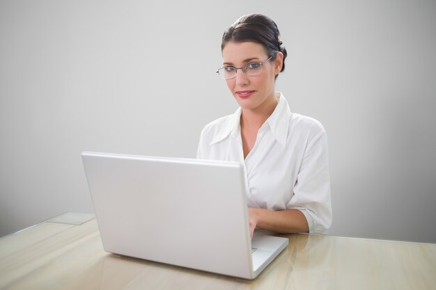 Cheerful businesswoman with classy glasses posing