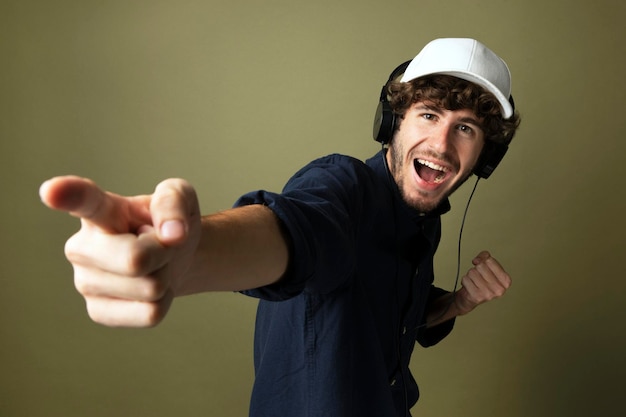 Cheerful casual man enjoying listening to music