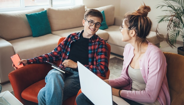 Cheerful caucasian couple with glasses working from home