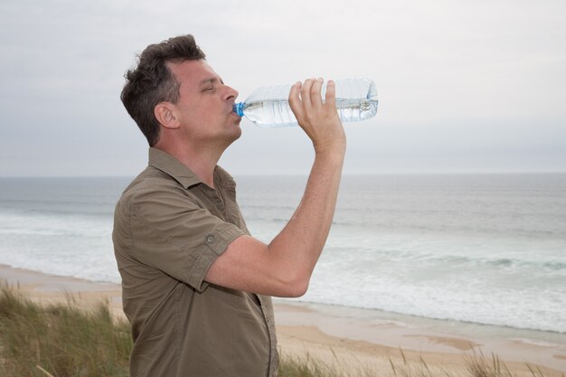 Cheerful caucasian man posing at the beach