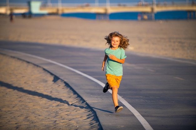 Cheerful child boy running to school kids run race