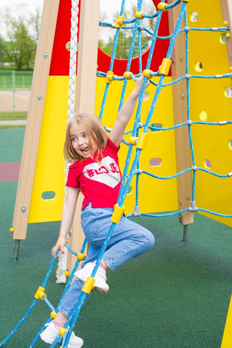 a cheerful child is playing in the children playground