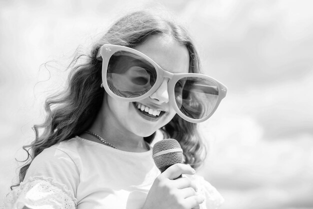 Cheerful child singer singing in microphone music style\
vocal