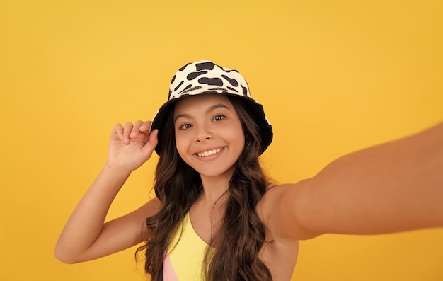 Cheerful child with curly hair make selfie fashion accessory express positive emotions